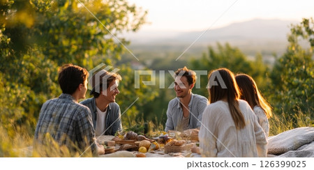 Friends share laughter and artisan snacks during a cozy picnic at golden hour surrounded by nature Friends share laughter and artisan snacks during a cozy picnic at golden hour surrounded by nature 126399025