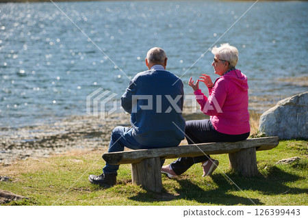 Elderly couple finding solace and joy as they rest on a park bench, engaged in heartfelt conversation, following a rejuvenating strol a testament to the enduring companionship and serene connection Elderly couple finding solace and joy as they rest on a park bench, engaged in heartfelt conversation, following a rejuvenating strol a testament to the enduring companionship and serene connection 126399443