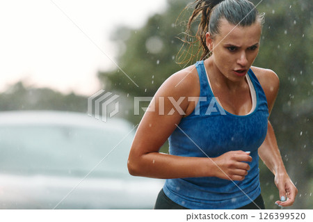 Unstoppable: A Determined Athlete Trains Through the Rain in Pursuit of Marathon Glory 126399520