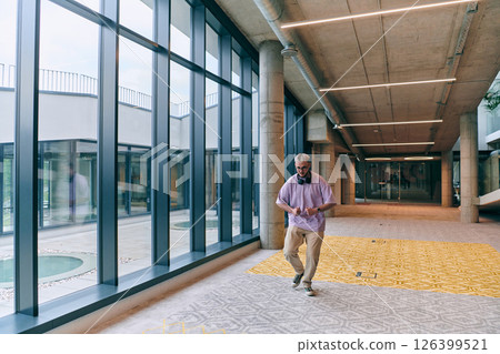Amidst an atmosphere of exuberance, a joyful, blonde man energetically departs for a business meeting, radiating positivity, enthusiasm, and a vibrant spirit in the contemporary corporate world 126399521