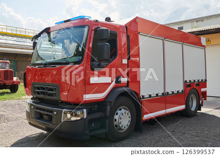 A state-of-the-art firetruck, equipped with advanced rescue technology, stands ready with its skilled firefighting team, prepared to intervene and respond rapidly to emergencies, ensuring the safety 126399537