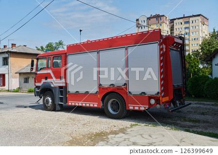 A state-of-the-art firetruck, equipped with advanced rescue technology, stands ready with its skilled firefighting team, prepared to intervene and respond rapidly to emergencies, ensuring the safety A state-of-the-art firetruck, equipped with advanced rescue technology, stands ready with its skilled firefighting team, prepared to intervene and respond rapidly to emergencies, ensuring the safety 126399649