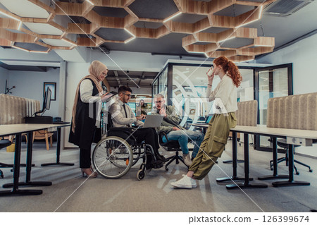 Young group of business people brainstorming together in a startup space, discussing business projects, investments, and solving challenges. 126399674