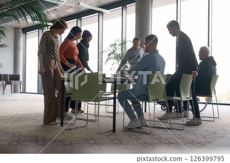 A diverse multiethnic business team engages in a collaborative meeting, discussing strategies and solutions in a modern office setting 126399795