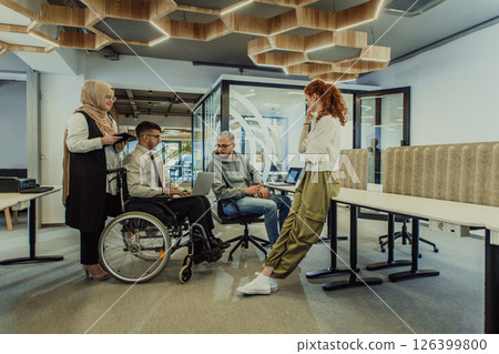 Young group of business people brainstorming together in a startup space, discussing business projects, investments, and solving challenges. 126399800