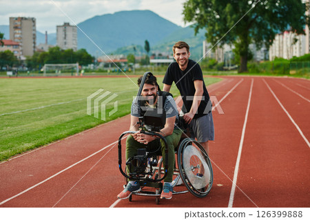 A cameraman filming the participants of the Paralympic race on the marathon course 126399888