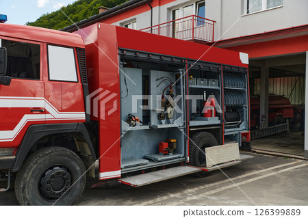 Close-up of essential firefighting equipment on a modern firetruck, showcasing tools and gear ready for emergency response to hazardous fire situations Close-up of essential firefighting equipment on a modern firetruck, showcasing tools and gear ready for emergency response to hazardous fire situations 126399889