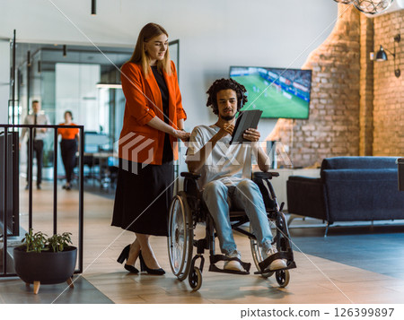 African-American businessman in a wheelchair engages in a collaborative discussion, using a tablet, with his business colleague, exemplifying the seamless integration of adaptive technology and African-American businessman in a wheelchair engages in a collaborative discussion, using a tablet, with his business colleague, exemplifying the seamless integration of adaptive technology and 126399897