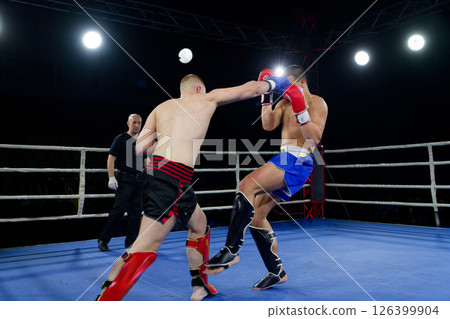 Fierce boxing match showcases athletes' power and skill. 126399904