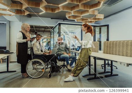 Young group of business people brainstorming together in a startup space, discussing business projects, investments, and solving challenges. Young group of business people brainstorming together in a startup space, discussing business projects, investments, and solving challenges. 126399941