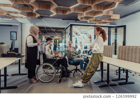 Young group of business people brainstorming together in a startup space, discussing business projects, investments, and solving challenges. 126399992