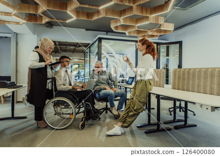 Young group of business people brainstorming together in a startup space, discussing business projects, investments, and solving challenges. Young group of business people brainstorming together in a startup space, discussing business projects, investments, and solving challenges. 126400080