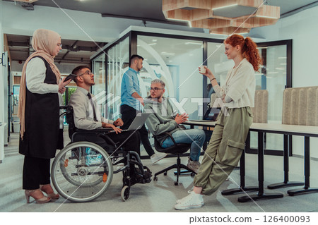 Young group of business people brainstorming together in a startup space, discussing business projects, investments, and solving challenges. Young group of business people brainstorming together in a startup space, discussing business projects, investments, and solving challenges. 126400093