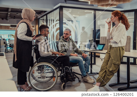 Young group of business people brainstorming together in a startup space, discussing business projects, investments, and solving challenges. 126400201