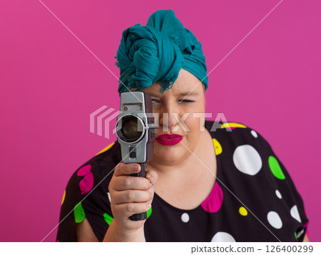 Colorful Woman Holding Vintage Camera in Quirky Studio Portrait 126400299