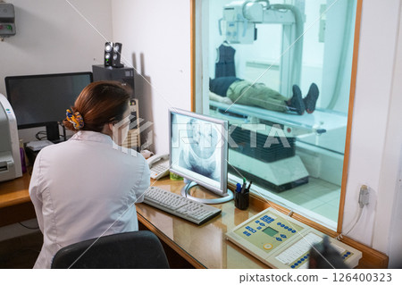 Radiologist Analyzing X-Ray Scans in a Medical Imaging Room. 126400323