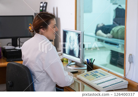Radiologist Analyzing X-Ray Scans in a Medical Imaging Room. 126400337