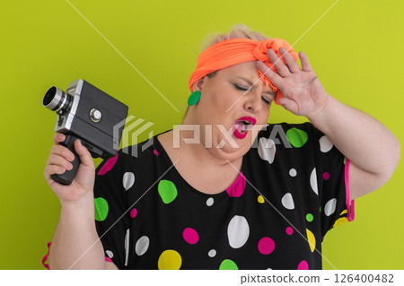 Colorful Woman Holding Vintage Camera in Quirky Studio Portrait 126400482