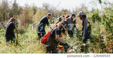 Group of people working together to clean trash and pollution from a forest.Generated image Group of people working together to clean trash and pollution from a forest.Generated image 126400505