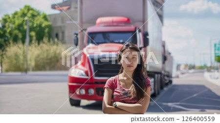Portrait of a Young Asian Truck Driver with Trucks in the Background.Generated image 126400559