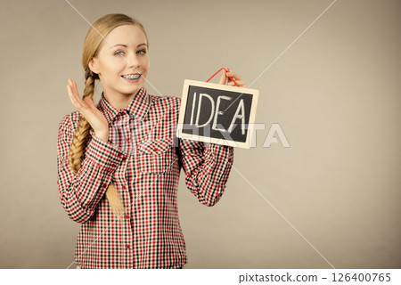 Proud confident woman holding idea sign Proud confident woman holding idea sign 126400765