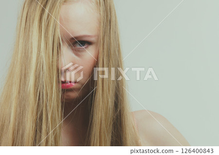 Sad girl covers her face with long hair 126400843