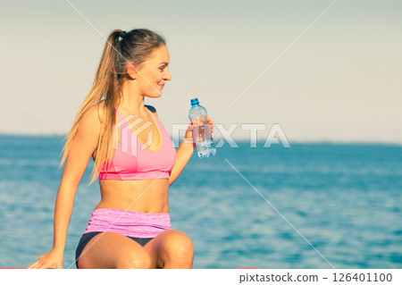 Woman drinking water after sport gym outdoor Woman drinking water after sport gym outdoor 126401100