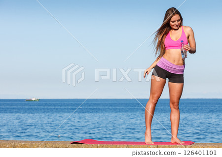 Woman drinking water after sport gym outdoor Woman drinking water after sport gym outdoor 126401101