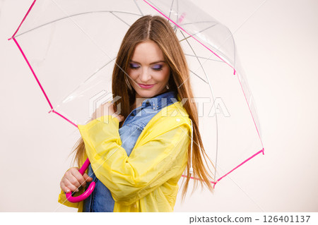 Woman wearing waterproof coat under umbrella Woman wearing waterproof coat under umbrella 126401137