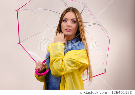 Woman wearing waterproof coat holding umbrella Woman wearing waterproof coat holding umbrella 126401138