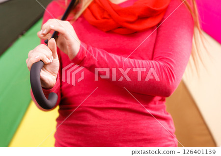 Woman standing under multicolored umbrella Woman standing under multicolored umbrella 126401139