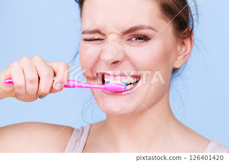 Woman brushing cleaning teeth Woman brushing cleaning teeth 126401420