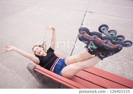 Crazy woman on bench wearing roller skates Crazy woman on bench wearing roller skates 126401535
