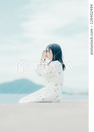 Profile portrait of a natural woman holding a film camera 126402494