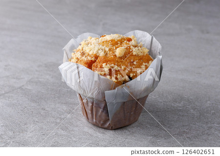 Streusel Muffin in Tulip Paper Cup on Gray Stone Background Streusel Muffin in Tulip Paper Cup on Gray Stone Background 126402651