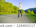 Man jogging in city partk at beautiful summer day. Sport fitness model caucasian ethnicity training outdoor. 126403117
