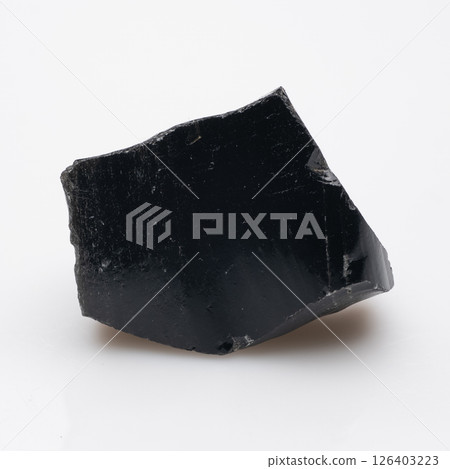 Volcanic Glass Fragment: A Raw Obsidian Piece Exhibiting a Dark, Glossy Surface and Angular Fracture - a Natural Rock Formation for Geology Study 126403223