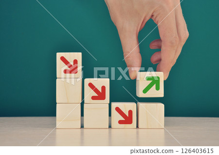 Businessman stacking wooden blocks into growing successful financial char 126403615