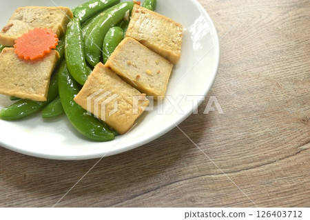 stir fried garden pea and carrot with slice tofu in soy sauce vegetarian food on dish 126403712