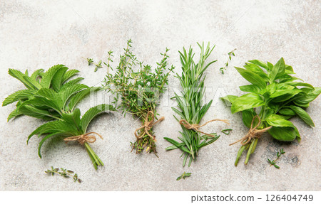 Freshly picked herbs tied in bunches on a textured surface 126404749