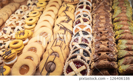 Assorted cookies and pastries display with chocolate, jam, and pistachio varieties Assorted cookies and pastries display with chocolate, jam, and pistachio varieties 126406186
