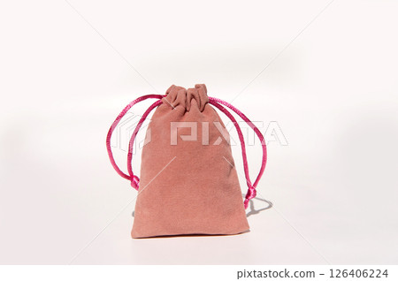 Pink velvet drawstring pouch with bright strings on white background 126406224
