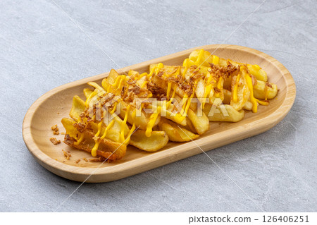 Cheesy French Fries with Crispy Onions on Bamboo Platter 126406251