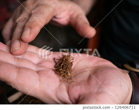 Preparing rolled cigarettes with dried tobacco. Preparing rolled cigarettes with dried tobacco. 126406711