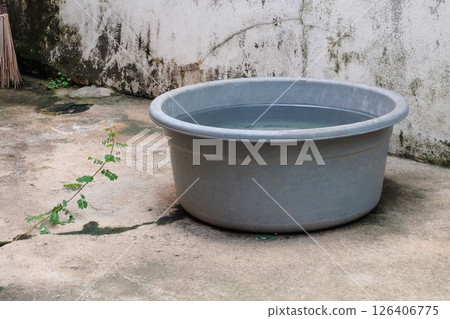 Rainwater catch basin,Rainwater stored in a bucket. 126406775