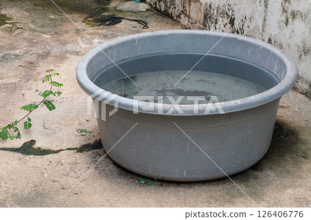 Rainwater catch basin,Rainwater stored in a bucket. Rainwater catch basin,Rainwater stored in a bucket. 126406776