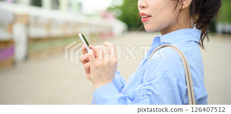 A woman touching a smartphone 126407512
