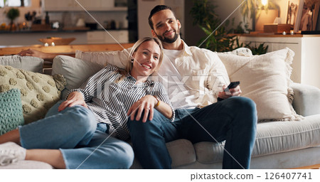 Couple, relax and watching tv on sofa, smile and home with streaming, film or love with bonding in lounge. People, woman and man with remote control on couch for movies, happy and show in living room Couple, relax and watching tv on sofa, smile and home with streaming, film or love with bonding in lounge. People, woman and man with remote control on couch for movies, happy and show in living room 126407741