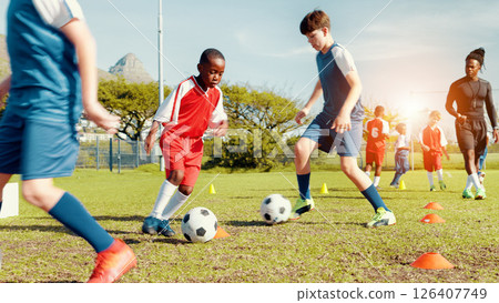 Sports field, soccer player and children with ball, kick and athlete with energy for practice in morning. Playing, football and kids with sportswear for game, growth and development with fitness 126407749