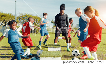 Sports field, soccer player and children with ball, training and athlete with energy for practice in morning. Playing, football and kids with sportswear for game, growth and development with fitness 126407750